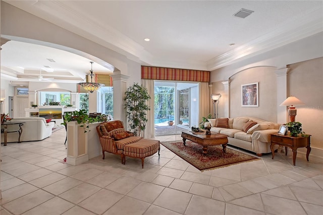 living room with visible vents, crown molding, light tile patterned floors, decorative columns, and a raised ceiling