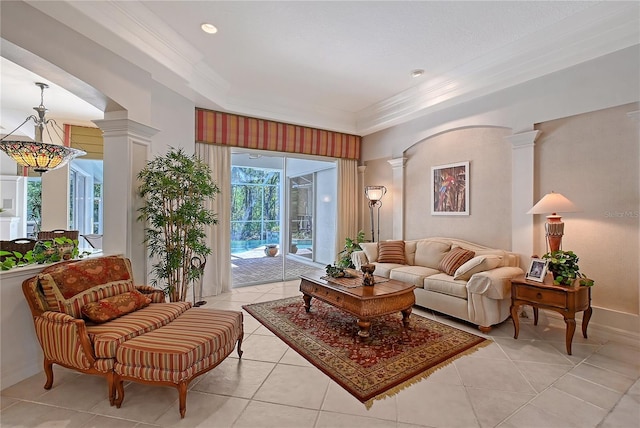 living area featuring light tile patterned floors, decorative columns, baseboards, and ornamental molding