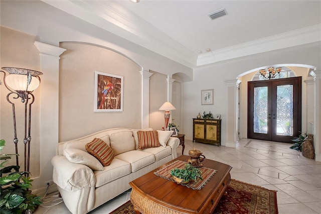 living area with visible vents, light tile patterned floors, french doors, arched walkways, and ornate columns