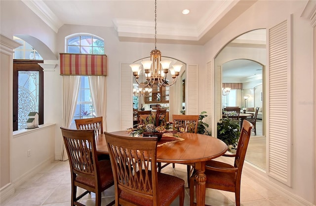 dining area with arched walkways, a notable chandelier, and ornamental molding