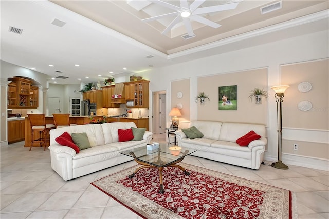 living area with visible vents, light tile patterned flooring, and ornate columns