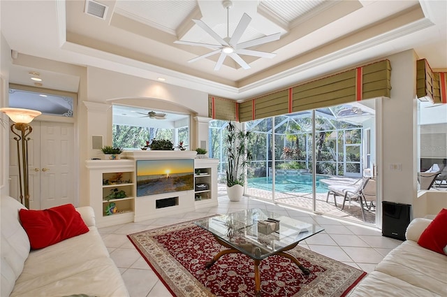 living room with tile patterned floors, visible vents, ceiling fan, and a sunroom