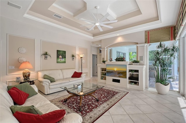 living area with a tray ceiling, visible vents, and light tile patterned flooring