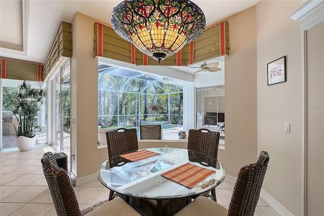 dining space with tile patterned floors, baseboards, and a sunroom