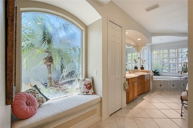 bathroom with vanity, tile patterned floors, a garden tub, and visible vents