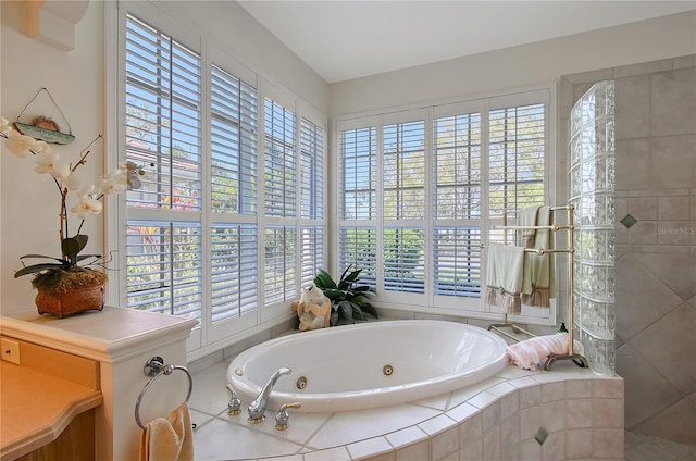 bathroom featuring a tub with jets and a walk in shower