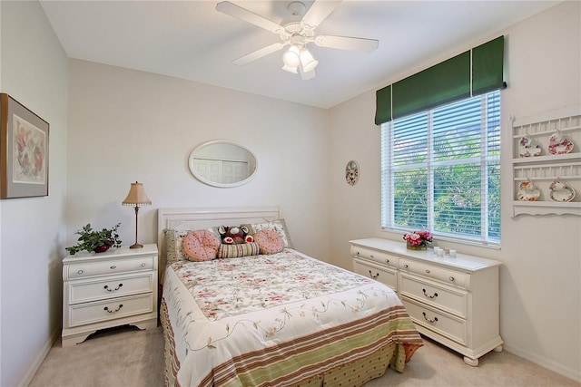 bedroom with baseboards, light carpet, and ceiling fan