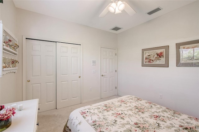 bedroom with visible vents, light colored carpet, a closet, and ceiling fan