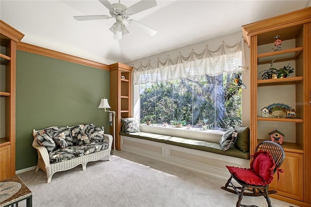 sitting room featuring a ceiling fan and carpet floors