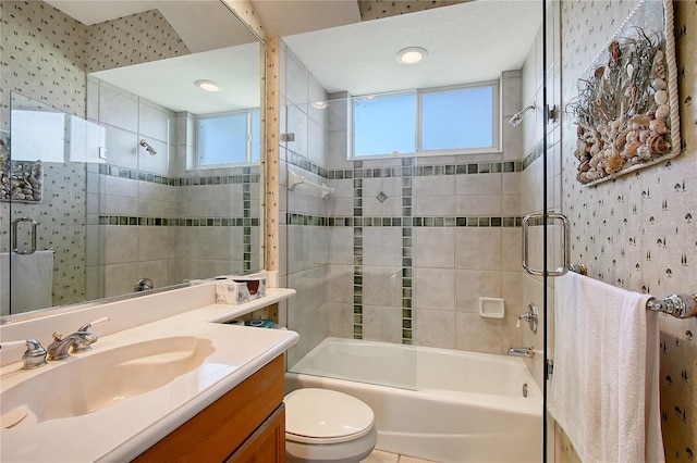 full bathroom with toilet, vanity, wallpapered walls, and shower / bathing tub combination