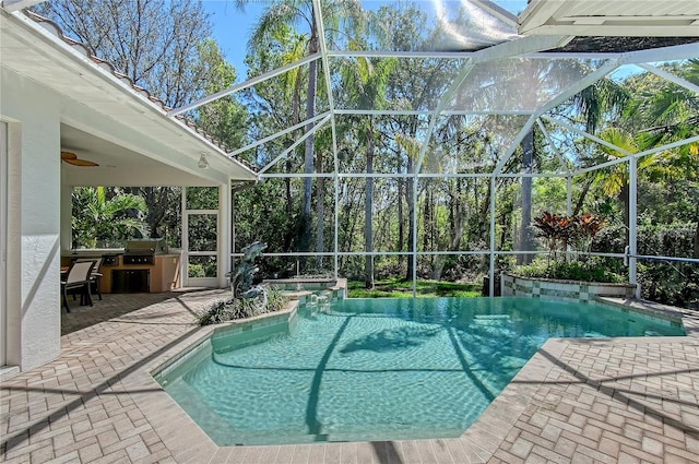 outdoor pool featuring ceiling fan, area for grilling, a lanai, and a patio area