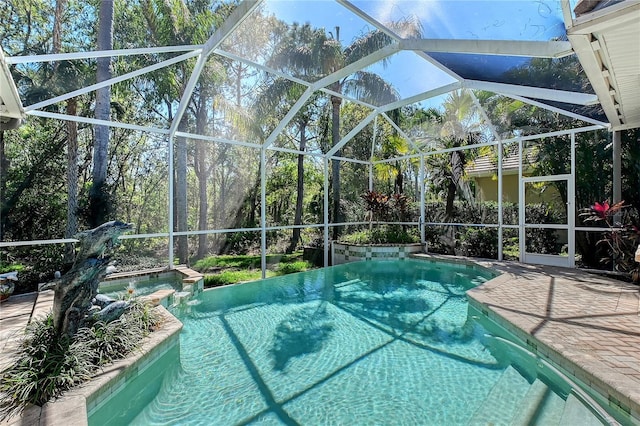 view of swimming pool with glass enclosure, a patio, and a pool with connected hot tub