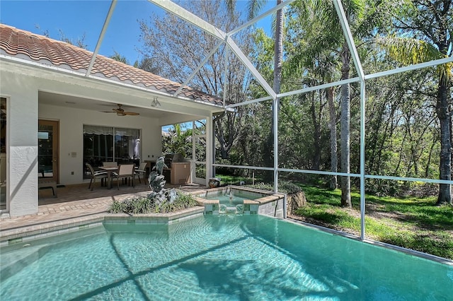 view of pool with a lanai, a patio area, a pool with connected hot tub, and ceiling fan