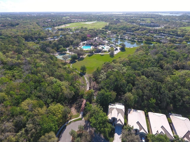 bird's eye view featuring a wooded view and a water view