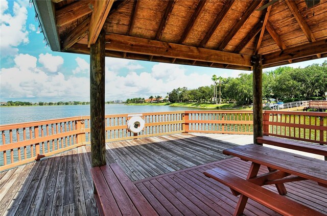 wooden terrace featuring a water view