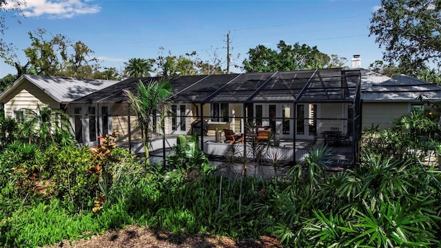 back of property with glass enclosure