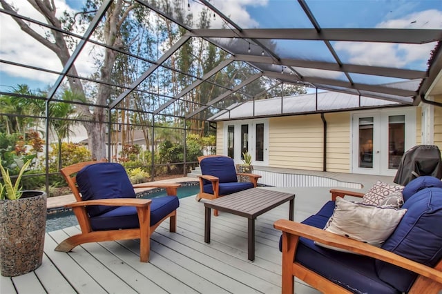 deck with french doors, outdoor lounge area, an outdoor pool, and a lanai