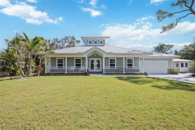 view of front facade featuring a porch, a garage, concrete driveway, french doors, and a front yard