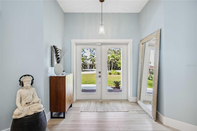 entryway featuring light wood-type flooring, baseboards, and french doors