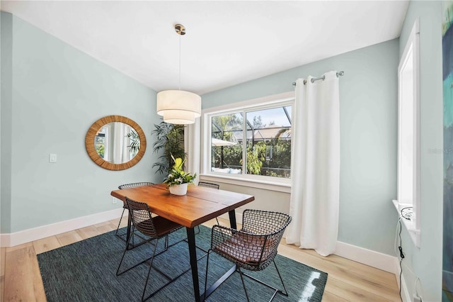 dining room featuring light wood-style flooring and baseboards