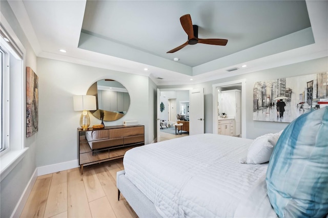 bedroom with recessed lighting, a raised ceiling, light wood-style flooring, and baseboards