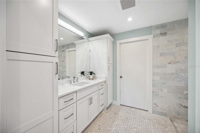 full bath featuring tile patterned floors, recessed lighting, tiled shower, and vanity