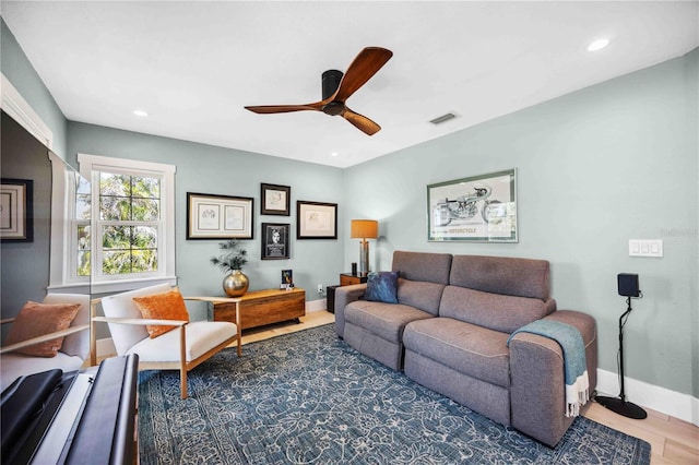 living room featuring recessed lighting, visible vents, baseboards, and wood finished floors