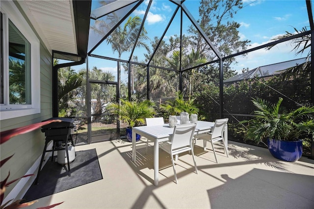 view of patio / terrace with glass enclosure and outdoor dining space