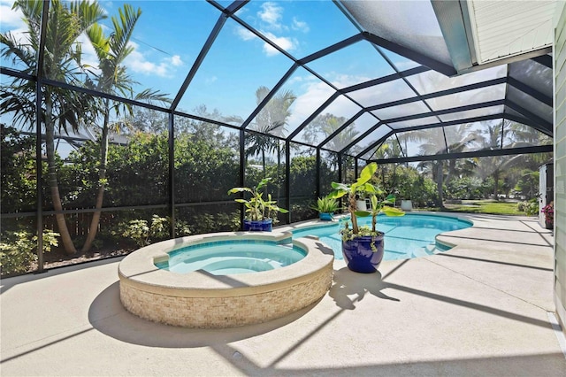 view of swimming pool with glass enclosure, a pool with connected hot tub, and a patio area