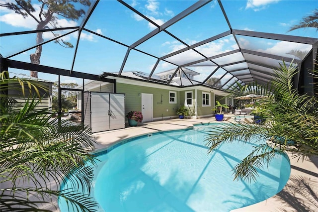 outdoor pool with a patio area and glass enclosure