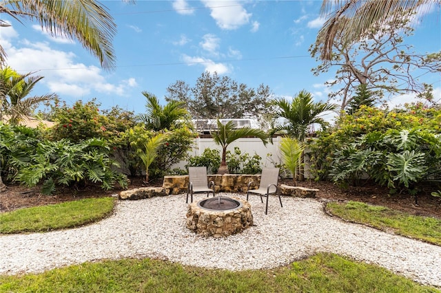 view of yard with an outdoor fire pit and fence