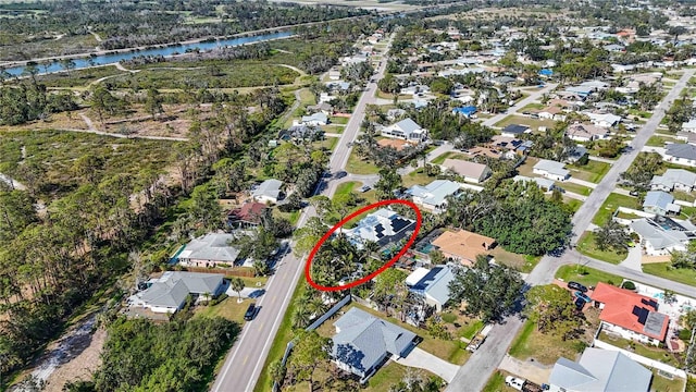 bird's eye view featuring a water view and a residential view