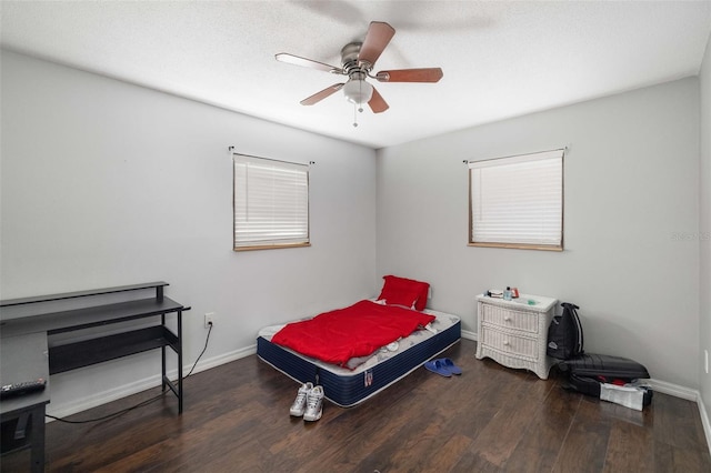 bedroom featuring a ceiling fan, baseboards, and wood finished floors