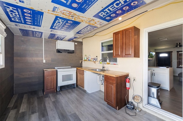 kitchen with dark wood-style flooring, a sink, light countertops, white range with electric stovetop, and brown cabinets