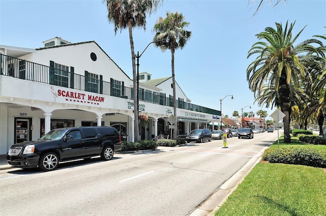 view of street featuring traffic signs, sidewalks, street lights, and curbs