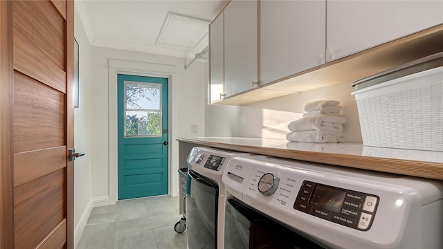 clothes washing area with washing machine and clothes dryer, light tile patterned floors, cabinet space, ornamental molding, and baseboards