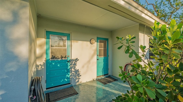 entrance to property featuring stucco siding