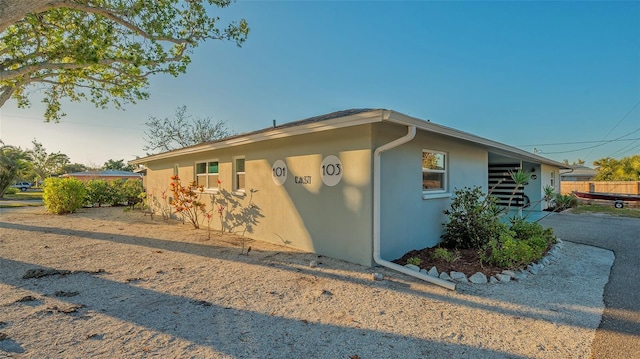 view of property exterior featuring driveway and stucco siding