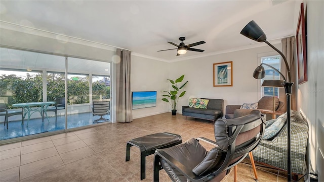 living room with ornamental molding, tile patterned flooring, and ceiling fan