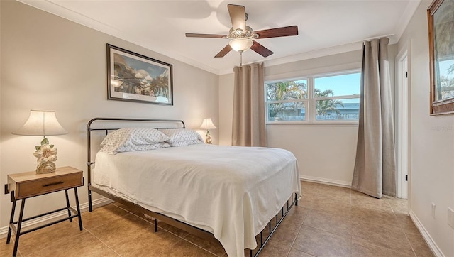 tiled bedroom with a ceiling fan, baseboards, and crown molding