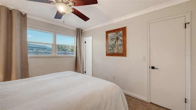 bedroom with crown molding, ceiling fan, and baseboards