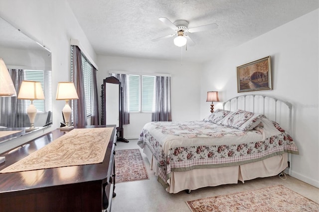 bedroom featuring light colored carpet, multiple windows, and a textured ceiling