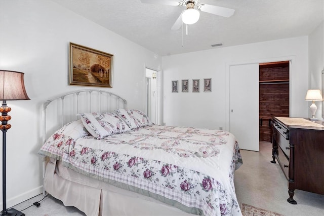 bedroom featuring a closet, visible vents, ceiling fan, a textured ceiling, and baseboards