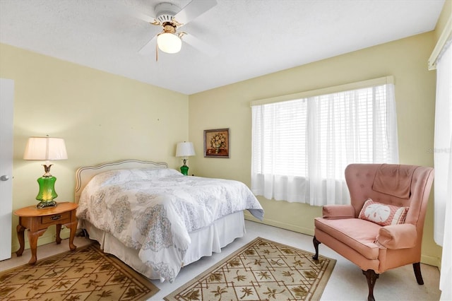 bedroom with ceiling fan and light colored carpet