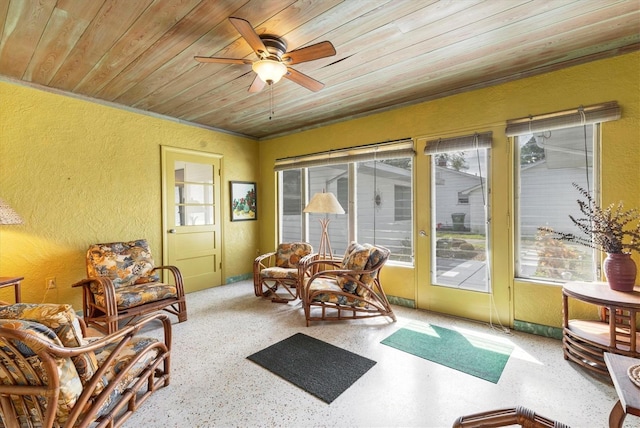 sunroom featuring ceiling fan, plenty of natural light, and wood ceiling