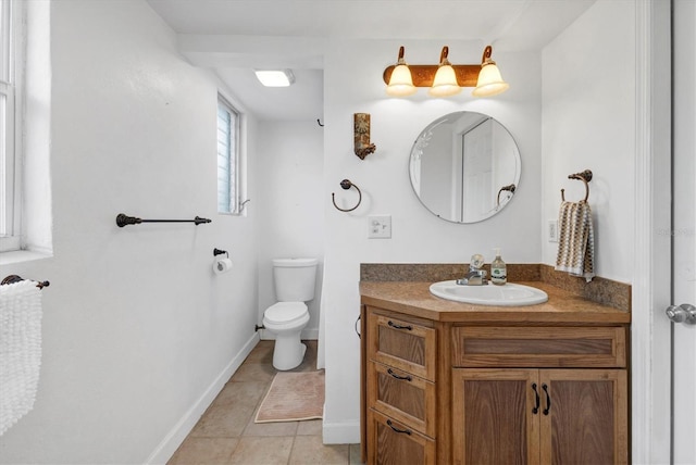 half bath with toilet, vanity, baseboards, and tile patterned floors