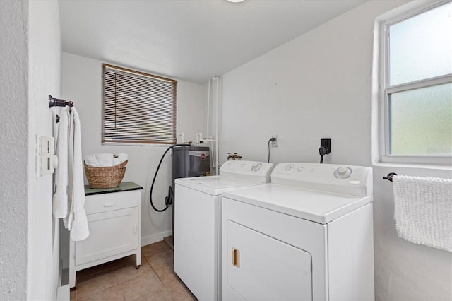 laundry room featuring light tile patterned floors, laundry area, and washer and dryer