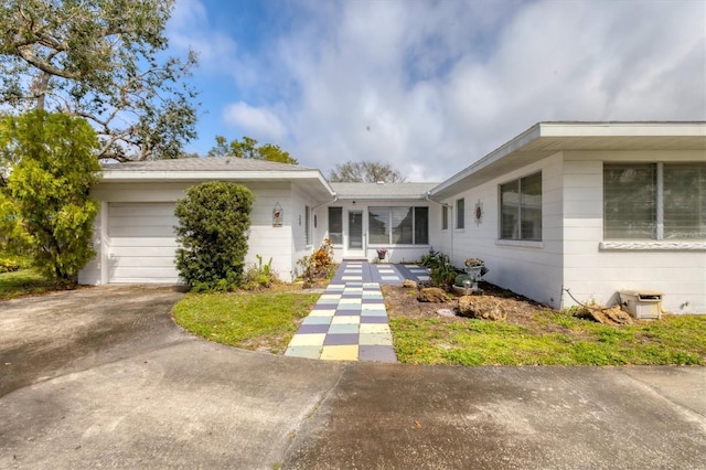 view of front of home featuring concrete driveway and an attached garage