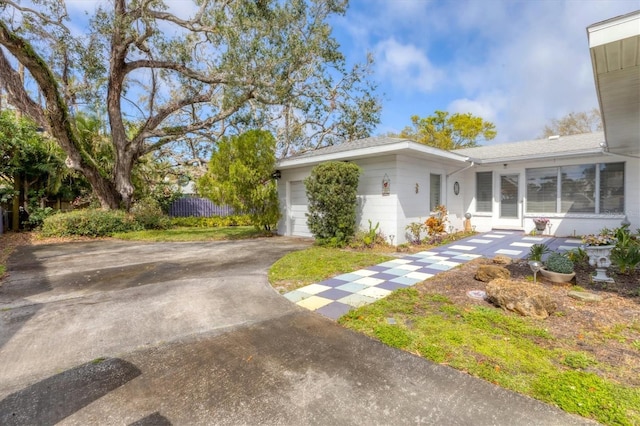 single story home with a garage and driveway