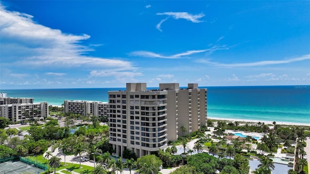 drone / aerial view of a large body of water and apartment complex / building